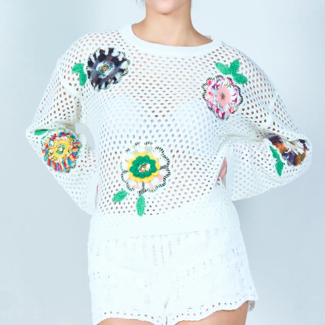 Open-knit sweater with colorful floral appliqués wholesale