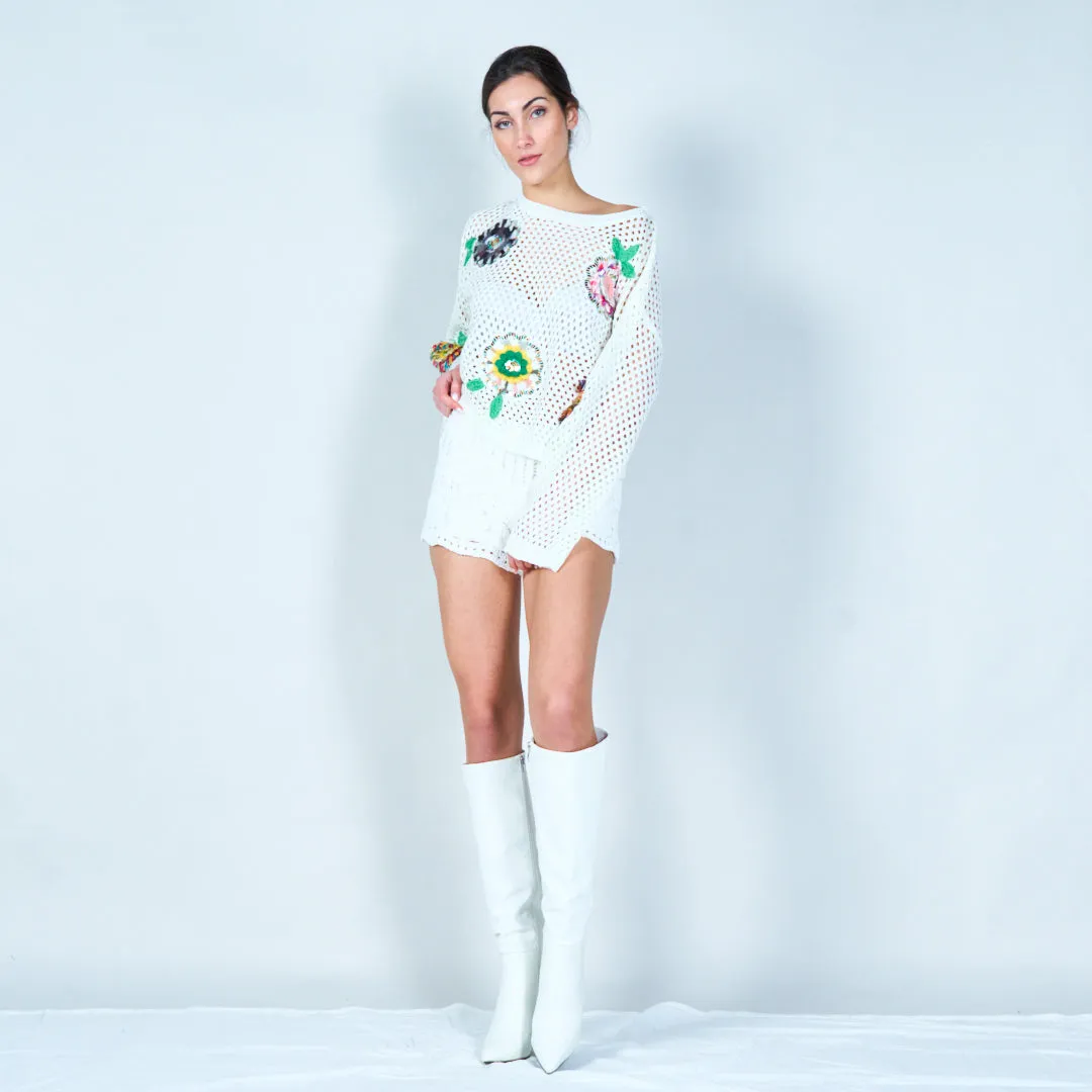 Open-knit sweater with colorful floral appliqués wholesale